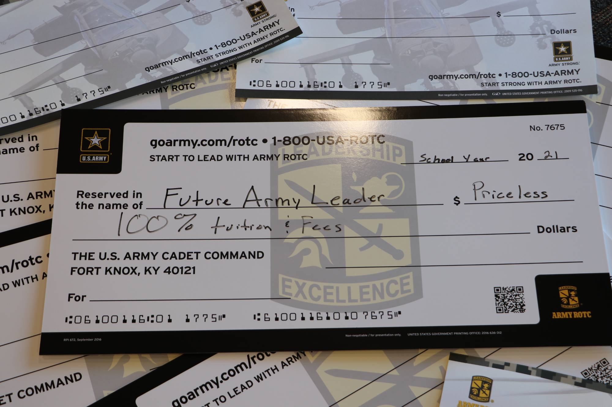 Large pile of ROTC scholarship checks made out to future leaders to cover 100% of college tuition